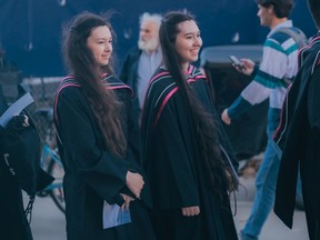 Sophia, left, and Isabel Jewell during their Nov. 7, 2022, convocation at the University of Toronto. The sisters — who are from Edmonton and began their post-secondary careers at the University of Alberta at age 14 and 12, respectively — recently completed master's degrees in Slavic language and culture.