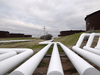 Pipelines run to Enbridge Inc.'s crude oil storage tanks at their tank farm in Cushing, Okla. The price of Alberta heavy crude is already US$30 lower than the price of the benchmark West Texas Intermediate.