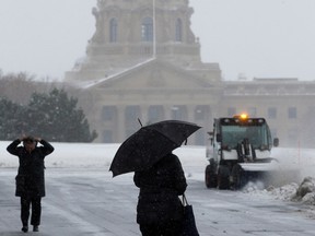 The Alberta Legislature is visible in the background as Edmontonians make their way through the blowing snow, in Edmonton, Wednesday, Nov. 2, 2022. Photo By David Bloom