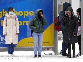 Commuters wait for a bus on 82 Avenue in Edmonton on Wednesday November 2, 2022. After the warmest October since 1944, winter arrived to the Edmonton region on Wednesday with snow and temperatures of -7C degrees.