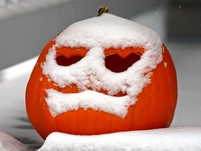 A snow-covered jack-o-lantern sits on the front porch of a home in southwest Edmonton on November 3, 3022.