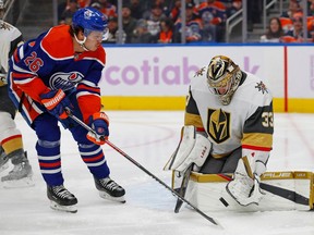 Nov 19, 2022; Edmonton, Alberta, CAN; Vegas Golden Knights goaltender Adin Hill (33) makes a save on a shot by Edmonton Oilers forward Mattias Janmark (26) during the first period at Rogers Place. Mandatory Credit: Perry Nelson-USA TODAY Sports
