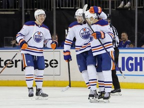 Nov 26, 2022; New York, New York, USA; Edmonton Oilers defenseman Brett Kulak (27) embraces Edmonton Oilers defenceman Evan Bouchard (2) after Bouchard's goal during the third period against the New York Rangers at Madison Square Garden. Mandatory Credit: Jessica Alcheh-USA TODAY Sports