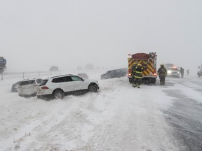 Emergency responders work at the scene of a multi-vehicle crash on Queen Elizabeth II Highway near Ponoka on Saturday, Nov. 5, 2022.