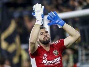Los Angeles FC goalkeeper Maxime Crepeau gestures to fans as he warms up for an MLS playoff soccer match against the LA Galaxy in Los Angeles on October 20, 2022.