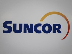 A Suncor logo is shown at the company's annual meeting in Calgary on May 2, 2019. Suncor Energy Inc. is reducing the size of its contractor work force by 20 per cent as part of its effort to improve safety and performance at its oilsands operations.