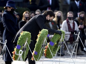 Prime Minister Justin Trudeau is accompanied by his wife Sophie Gregoire Trudeau as he places a wreath at the National War Memorial during the National Remembrance Day Ceremony in Ottawa, on Thursday, Nov. 11, 2021.