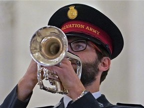 Colin Williams blows the trumpet of the Salvation Army Edmonton Temple Band during a memorial service at the Alberta Legislature on Thursday, November 3, 2022.