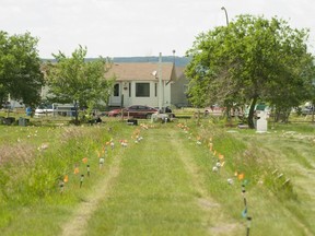 Flags mark where ground-penetrating radar recorded hits of what are believed to be 751 unmarked graves in this cemetery near the grounds of the former Marieval Indian Residential School on the Cowessess First Nation, Sask., June 26, 2021.