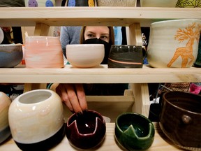 Alexis Millar arranges ceramics at the AEM Ceramics booth at the Royal Bison Art and Craft Fair on Sunday, November 27, 2022 at the Old Strathcona Performing Arts Center at 8426 Gateway Boulevard in Edmonton. The fair runs through his December 2nd-4th.