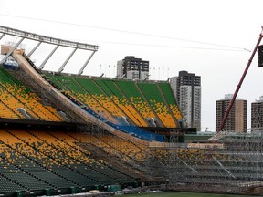 Construction workers on a giant snowboard ramp in preparation for The Style Experience FIS Snowboard Big Air World Cup on Sunday, November 27, 2022 at Commonwealth Stadium in Edmonton. The event is his December 10, 2022.