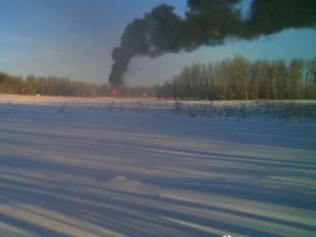 Trail cam photos show smoke and flames rising above the tree line after two semi-trucks collided on Highway 16 near Range Road 111 west of Edmonton on Friday, Nov. 11, 2022. Supplied photo/Hunting Shilee
