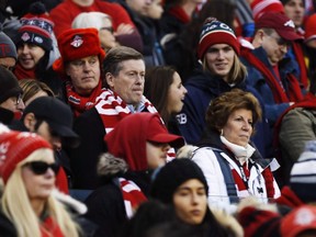 Toronto Mayor John Tory sits with fans as they wait for the start of MLS Cup Final soccer action between the Seattle Sounders and Toronto FC in Toronto on Saturday, Dec. 9, 2017.
