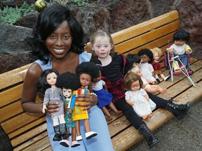 Andile Pfupa, imports and sells dolls of every skin colour, including some with visible disabilities. Playing with some of the dolls beside her is Violet Rivard.