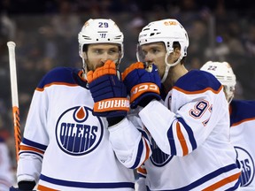 Leon Draisaitl and Connor McDavid of the Edmonton Oilers talk during the third period against the New York Rangers at Madison Square Garden on November 26, 2022 in New York City. Seconds later, their well-laid plans were converted into the game-winning goal as the Oilers defeated the Rangers 4-3.