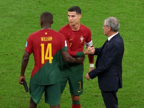 Fernando Santos, Head Coach of Portugal, interacts with William Carvalho and Cristiano Ronaldo after the 6-1 win during the FIFA World Cup Qatar 2022 Round of 16 match between Portugal and Switzerland at Lusail Stadium on December 06, 2022 in Lusail City, Qatar.