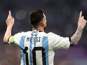 Lionel Messi of Argentina celebrates scoring the first goal from the penalty spot against Morocco.