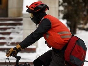 Un cycliste habillé pour les promenades hivernales dans la voie cyclable de la 100 Avenue près de la 102 Street au centre-ville d'Edmonton le mercredi 2 février 2020.  12, 2020. Photo par Ian Kucerak/Postmedia