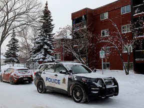 Members of the Edmonton Police Service continue to work at an apartment building at 10614 103 Street, in Edmonton Monday Dec. 19, 2022. A 36-year-old man suffering fatal gunshot wounds Sunday Dec. 18 at a central Edmonton parking lot in what may be the city's latest homicide.