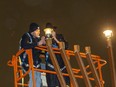 Mark Drelich lights the first lantern with the help of his father Rabbi Ari Drelich during the 31st annual menorah lighting ceremony in honour of Chanukah, (the Festival of Lights) at the Alberta legislature on Dec. 18, 2022.