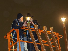 Mark Drelich lights the first lantern with the help of his father Rabbi Ari Drelich during the 31st Annual menorah Lighting Ceremony in honour of Chanukah, (the Festival of Lights) at the Alberta Legislature on Sunday, Dec. 18, 2022 in Edmonton.