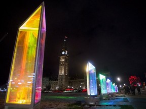 Interactive colourful prisms are seen on the lawn on Parliament Hill during the launch of Christmas Lights Across Canada, on Wednesday, Dec. 7, 2016 in Ottawa.