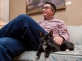 House Speaker Nathan Cooper with Hansard the cat, in his office on Thursday, Dec. 1, 2022 in Edmonton. Hansard is a rescue cat the House Speaker got and named after the official legislature record.
