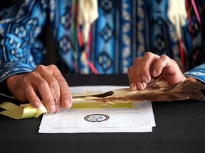 Onion Lake Cree Nation Chief Henry Lewis holds a pen in his hands after announcing in Edmonton Monday, December 19, 2022 that his nation has filed a lawsuit against Alberta over the Alberta Sovereignty Act to amend its treaty and constitutional Protect rights guaranteed by Contract 6.