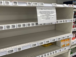 A sign on empty shelves in the children's cough and cold section of a pharmacy in Timmons, Ont., tells shoppers they will be limited to one product per customer.