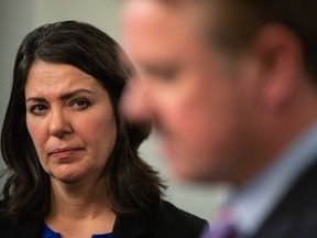 Alberta Premier Danielle Smith watches Justice Minister Tyler Shandro speak at a news conference after the speech from the throne in Edmonton on  Nov. 29, 2022.