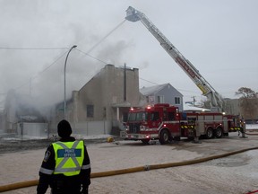 A boarded up church on the corner of 98 Street and 107 Avenue in central Edmonton is consumed by fire on Dec. 27, 2022.