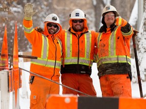 EPCOR crews mug for the camera as they work to repair a burst water line near 83 Avenue and 108 Street in Edmonton, Sunday Dec. 25, 2022. Photo By David Bloom