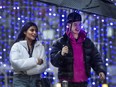 Two seemingly happy people stroll through Toronto's Yorkville area in December.