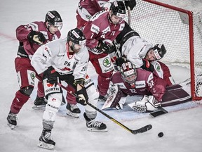 Canada's David Desharnais fights for the puck against Sparta's goalkeeper Josef Korenar during the game between the Czech Republic's Sparta Prague and Team Canada, at the 94th Spengler Cup ice hockey tournament in Davos, Switzerland, Monday, Dec. 26, 2022.