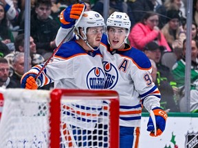 Dec 21, 2022; Dallas, Texas, USA; Edmonton Oilers center Mattias Janmark (26) and center Ryan Nugent-Hopkins (93) celebrates a goal scored by Janmark against the Dallas Stars during the first period at the American Airlines Center. Mandatory Credit: Jerome Miron-USA TODAY Sports
