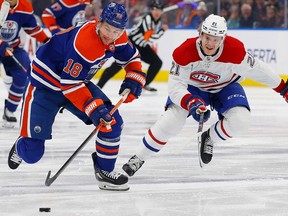 Dec 3, 2022; Edmonton, Alberta, CAN; Montreal Canadiens defensemen Kaiden Guhle (21) chases Edmonton Oilers forward Zach Hyman (18) up the ice during the first period at Rogers Place. Mandatory Credit: Perry Nelson-USA TODAY Sports
