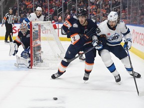 Dec 31, 2022; Edmonton, Alberta, CAN; Edmonton Oilers defenseman Evan Bouchard (2) and Winnipeg Jets centre Kevin Stenlud (28) battle in front of Oilers goalie Jack Campbell (36) during the second period at Rogers Place. Mandatory Credit: Walter Tychnowicz-USA TODAY Sports