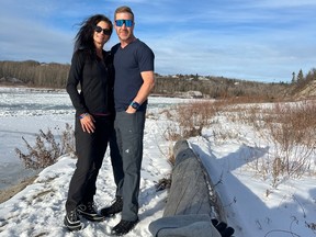 Matt Devine and his wife Nicole Devine, now both retired, relax on the banks of the North Saskatchewan River near their home.