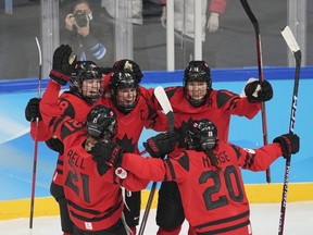 Team Canada forward Marie-Philip Poulin (29) celebrates her goal against the United States with teammates Micah Zandee-Hart, left to right, Ashton Bell, Brianne Jenner and Sarah Nurse during second period women's hockey gold medal game action at the 2022 Winter Olympics in Beijing on Thursday, Feb. 17, 2022.