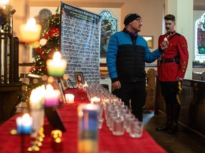 Livio Fent lights a candle for his two-year-old grandson who was killed by a drunk driver, during a candlelight vigil put on by Mothers Against Drunk Driving, in Edmonton Alberta, December 4, 2022.
