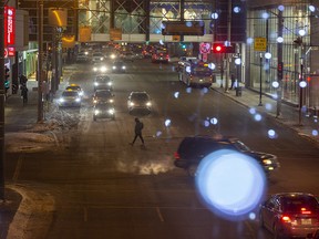 Christmas lights are reflected in the glass of a pedway as evening traffic heads home from downtown Edmonton on Monday, Dec. 12, 2022, in Edmonton.