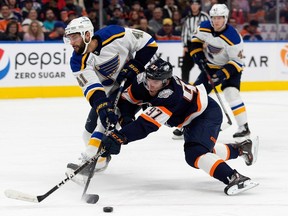 The Edmonton Oilers' Connor McDavid (97) battles the St. Louis Blues' Robert Bortuzzo (41) during first period NHL action at Rogers Place, in Edmonton Thursday Dec. 15, 2022. Photo By David Bloom