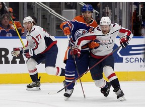 The Edmonton Oilers' Darnell Nurse (25) battles the Washington Capitals' Nick Jensen (3) during first period NHL action at Rogers Place, in Edmonton Monday Dec. 5, 2022. Photo By David Bloom