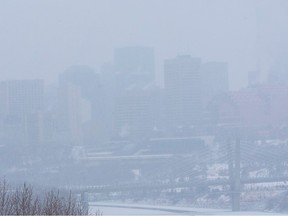 The downtown skyline is obscured by heavy snow on Friday, Dec. 16, 2022 in Edmonton.
