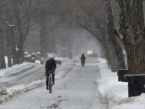 Cyclists use the bike lane along 83 Ave. as a brief snow fall moves through Edmonton, February 4, 2020.
