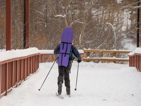 A cross country skier make their way across the Capilano Footbridge on Wednesday, Dec. 28, 2022, in Edmonton.