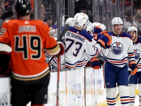 Vincent Desharnais #73 congratulates Klim Kostin #21 of the Edmonton Oilers after his goal as Max Jones #49 of the Anaheim Ducks looks on during the second period of a game at Honda Center on January 11, 2023 in Anaheim, California.