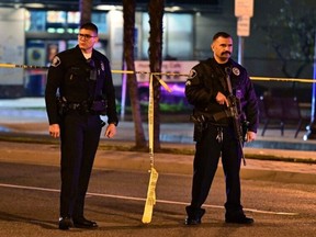 Police stand guard at the scene along Garvey Avenue in Monterey Park, California, on January 22, 2023, where police are responding to reports of multiple people shot. - Police were at the scene of a shooting in southern California that has caused a number of casualties, the Los Angeles Times reported January 22, citing a law enforcement source.