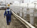 A worker walks along a new pipeline at the Enbridge facility in the east of Edmonton. File photo.