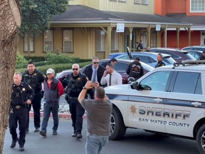 Police officers detain a man, believed by law enforcement to be the Half Moon Bay mass shooting suspect, in Half Moon Bay, California, U.S., January 23, 2023, in this screengrab taken from a social media video. Kati McHugh via REUTERS